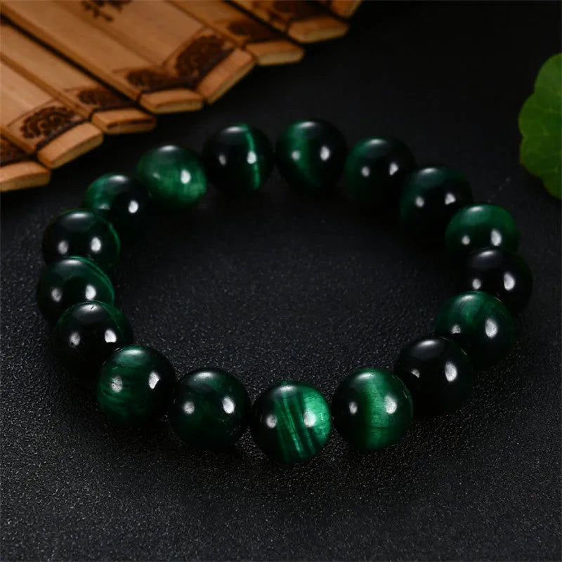 Green Tiger Eye stone bracelet with polished geometric beads on a wrist