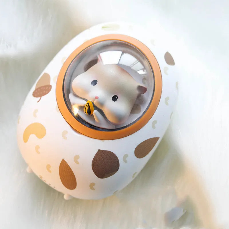 White Hamster hand warmer power bank with space capsule design showing charging port and heating controls
