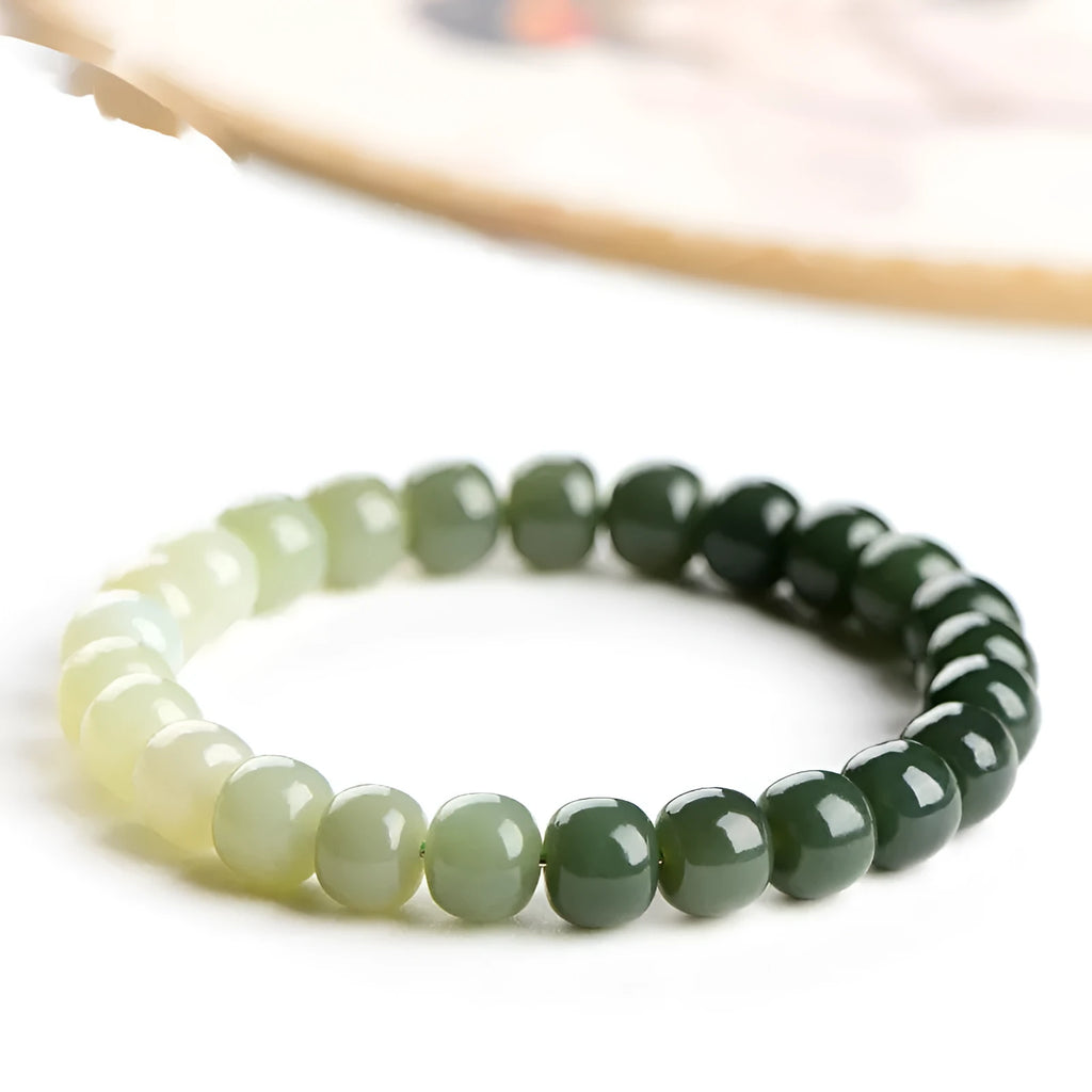 Natural Hetian Jade bracelet with gradient clear water colour on wrist, showing polished beads.
