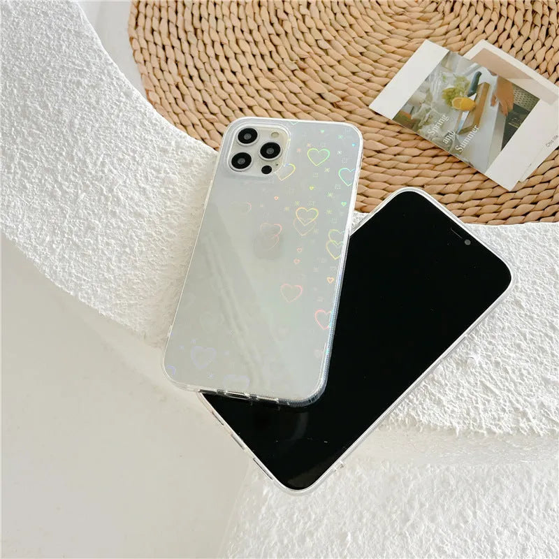 Transparent silicone iPhone case with a laser-etched love heart design on the back.