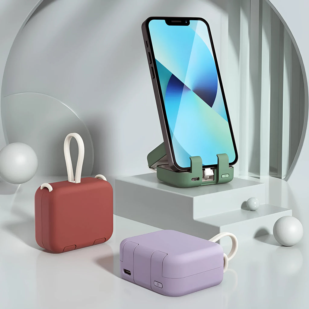 Red portable power bank with an extended bracket holding a mobile phone.