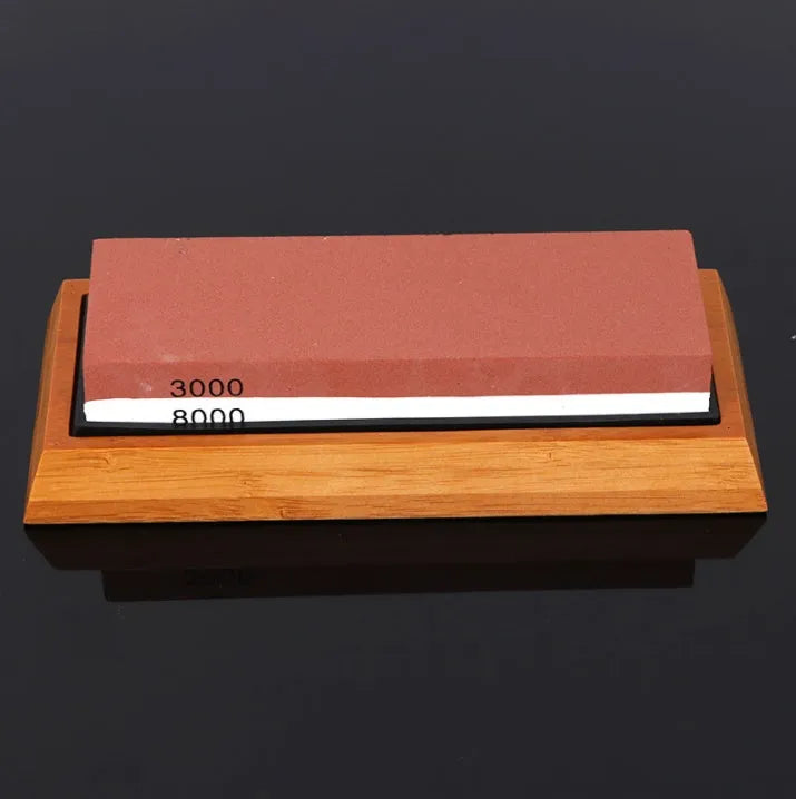 White corundum kitchen whetstone on bamboo base with correction stone and accessories
