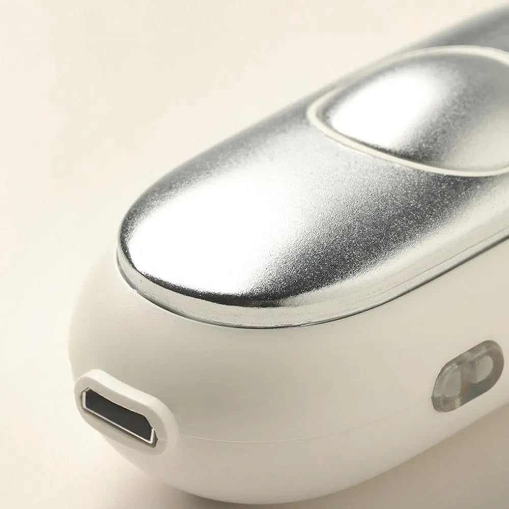 Handheld microcurrent sleep aid device with round control button in grey, green, or orange colours