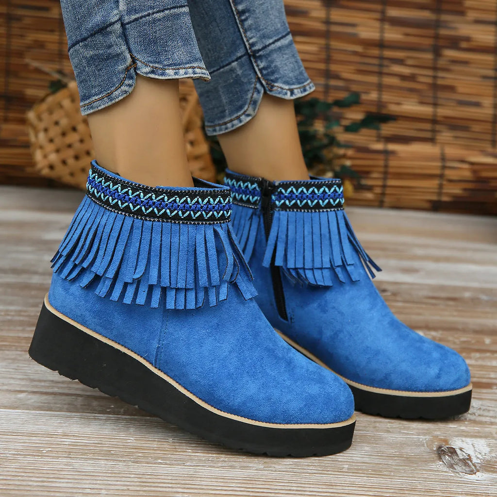 Women's dark brown suede ankle boots with a thick wedge sole, side zip, and decorative tassel.