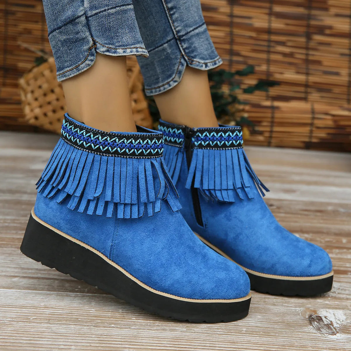 Women's dark brown suede ankle boots with a thick wedge sole, side zip, and decorative tassel.