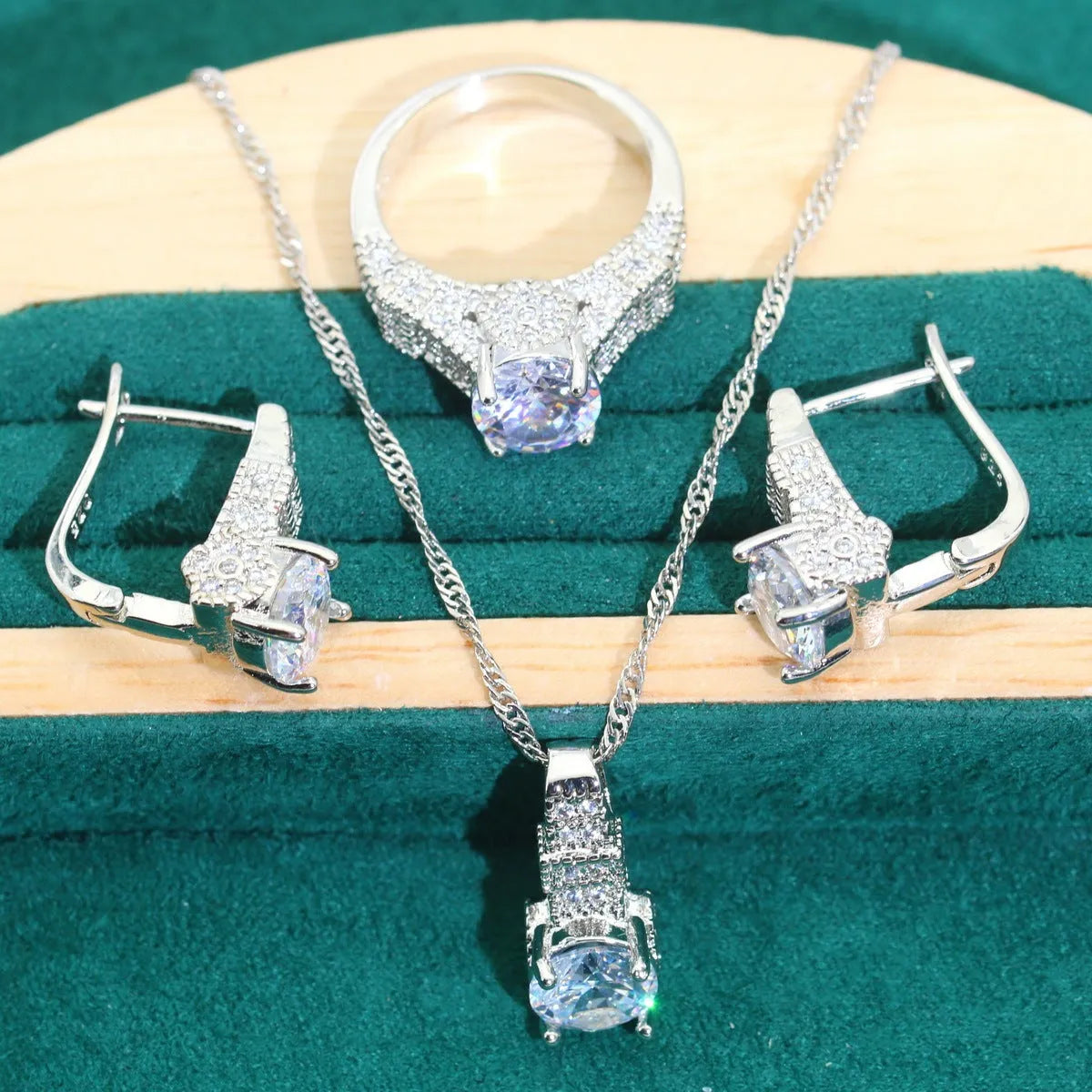 Bridal zircon and alloy four-piece jewellery set showing necklace, earrings, bracelet, and ring in white colour