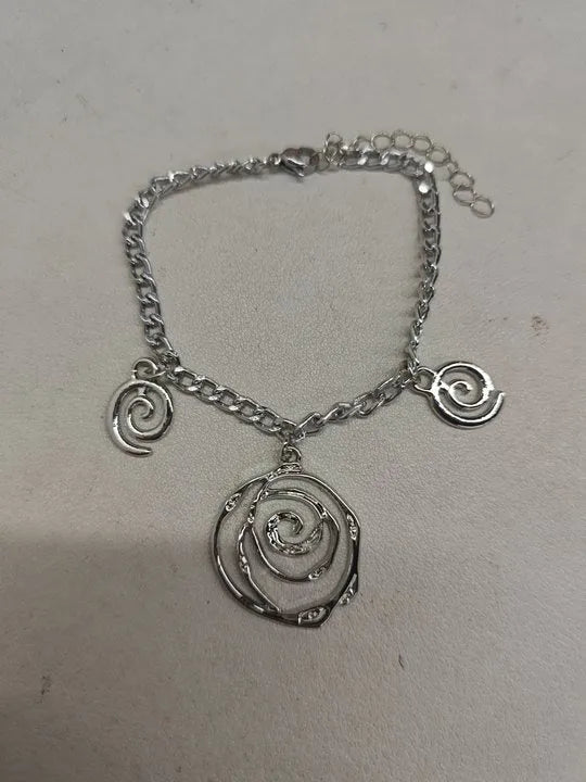 Spiral donut design women's jewellery set showing necklace, bracelet and ear hooks in gold or silver finish