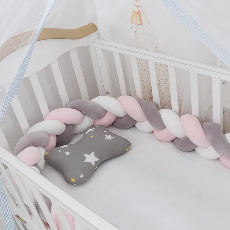 Baby crib bumper protector in spandex velvet, bent to show flexible shape, against a crib rail.