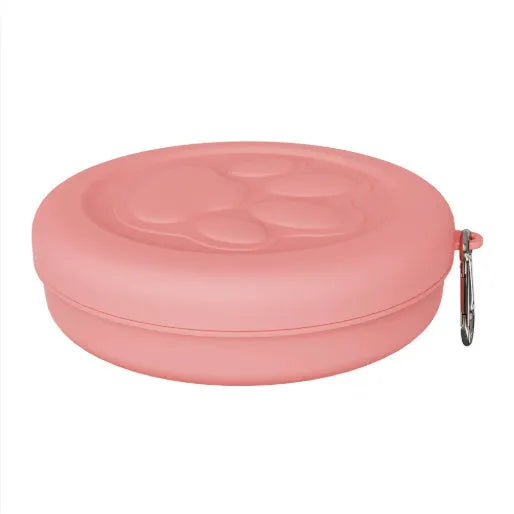 A collapsed and opened portable silicone dog bowl in a light pink colour, showing its flexible design.