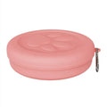 A collapsed and opened portable silicone dog bowl in a light pink colour, showing its flexible design.