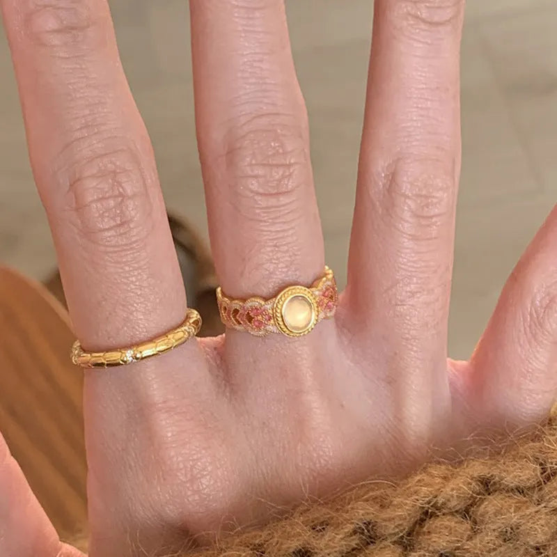 Women's geometric open ring with pink crystal enamel finish on adjustable copper gold plating