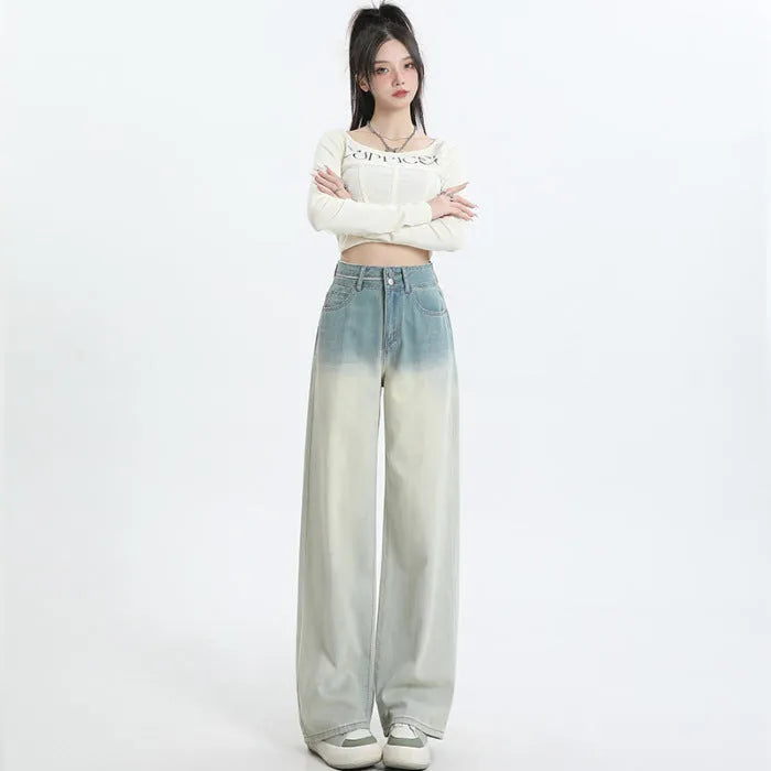 Gradient blue women's straight-leg denim trousers on a hanger, showing colour transition.