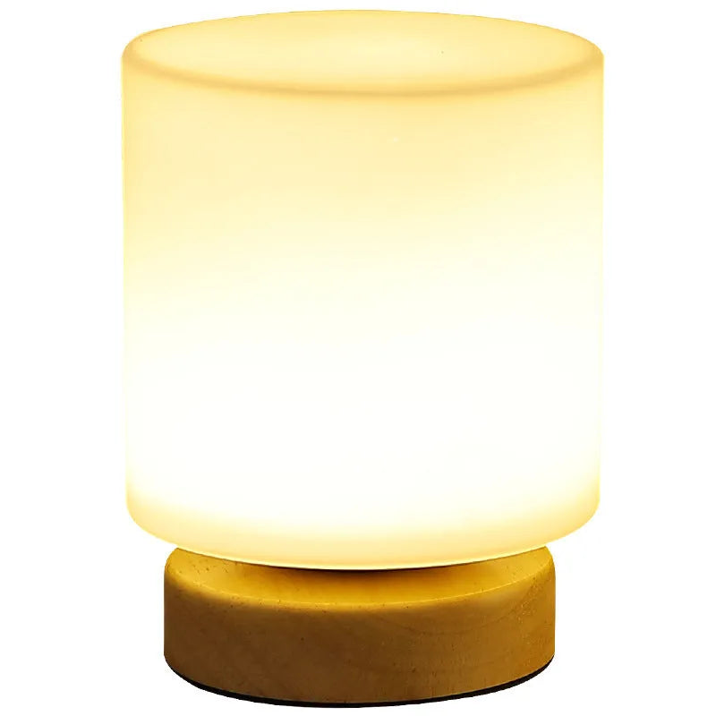 White Nordic solid wood USB table lamp with touch dimming in cube shape on a wooden table.