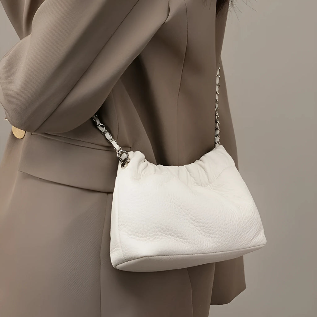 Women's soft genuine leather dumpling-shaped crossbody bag in grey with a chain shoulder strap.