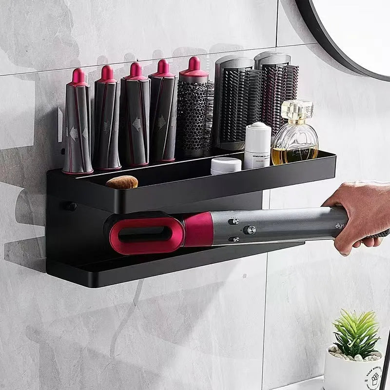 White two-layer aluminium punch-free bathroom storage rack mounted on a wall holding hair curlers.