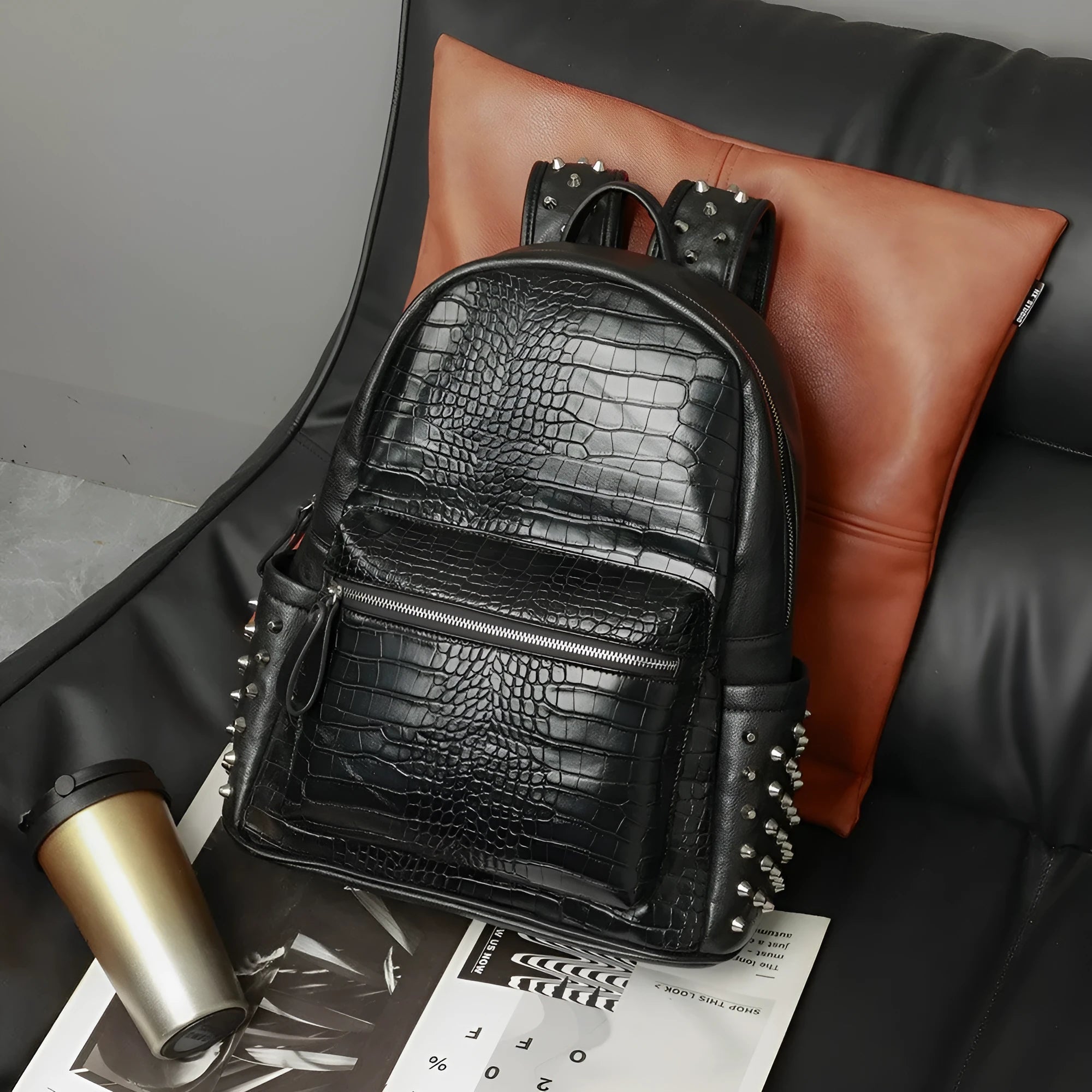 Black waterproof computer schoolbag with 55L capacity and decorative rivet details