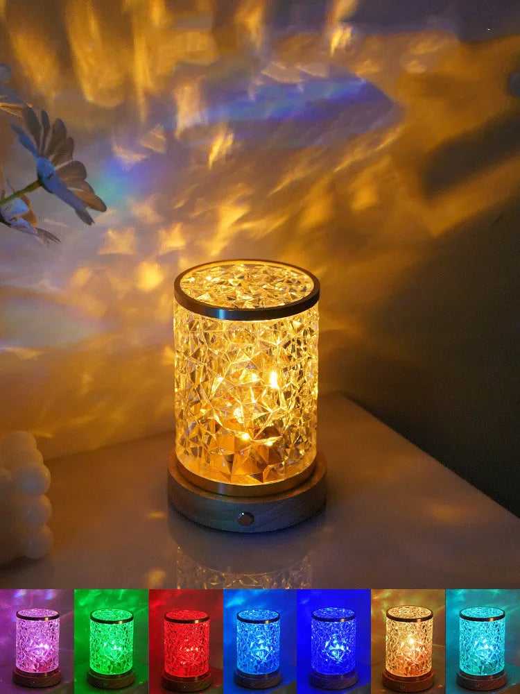 Compact rotating water ripple effect LED night light with solid wood base on a bedside table.