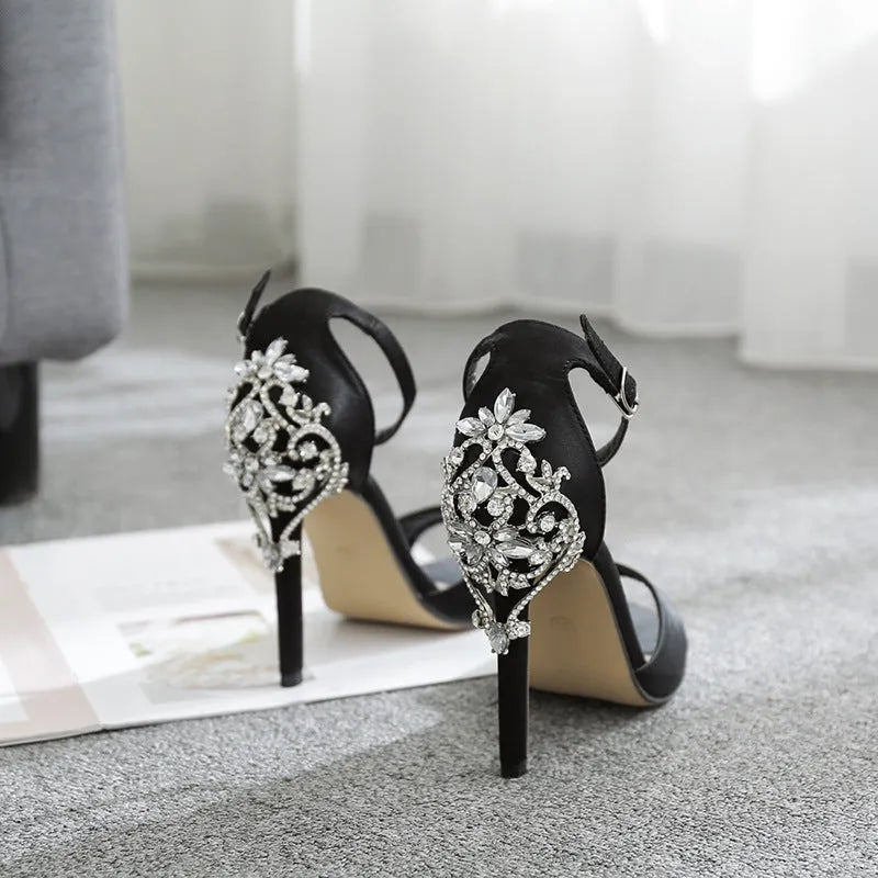 Black suede women's high heel shoes with rhinestone details and a fish mouth toe.