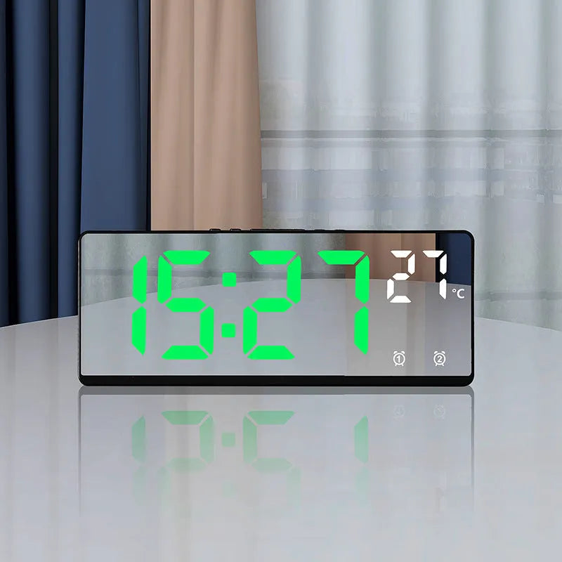 Electronic alarm clock with large LED screen showing time and temperature on desktop