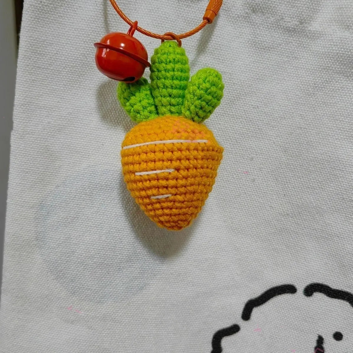 Wool cartoon carrot-shaped keychain pendant on a key ring.