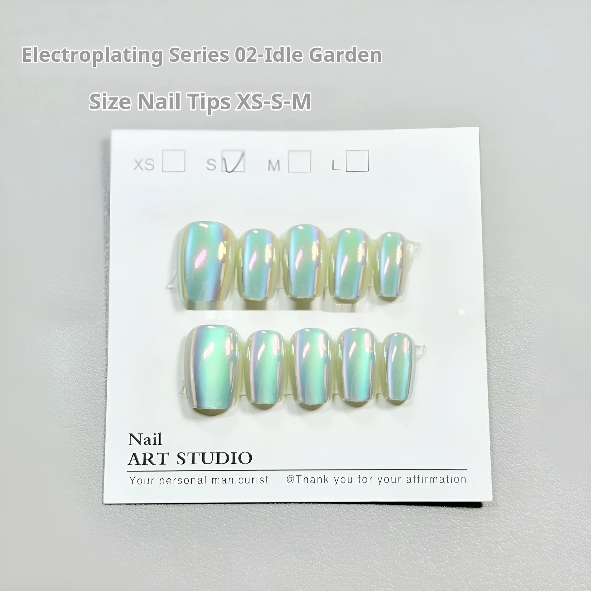 Electroplating Cat's Eye 02 Idle Court false nails with Aurora effect in short ladder sizes on a hand.