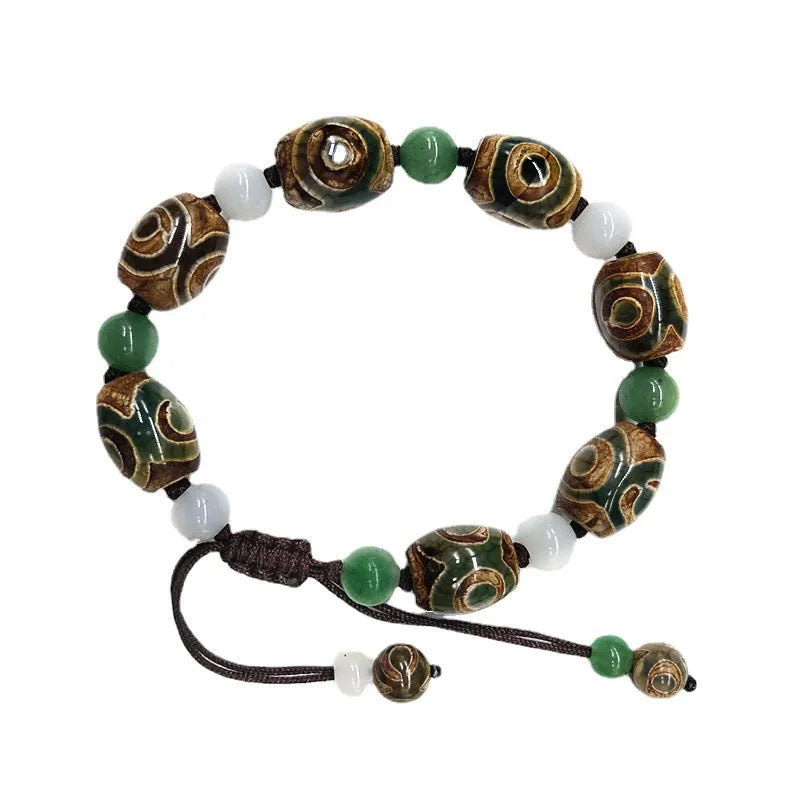 Green agate ethnic bracelet with a large three-eye bead and hand-woven band.