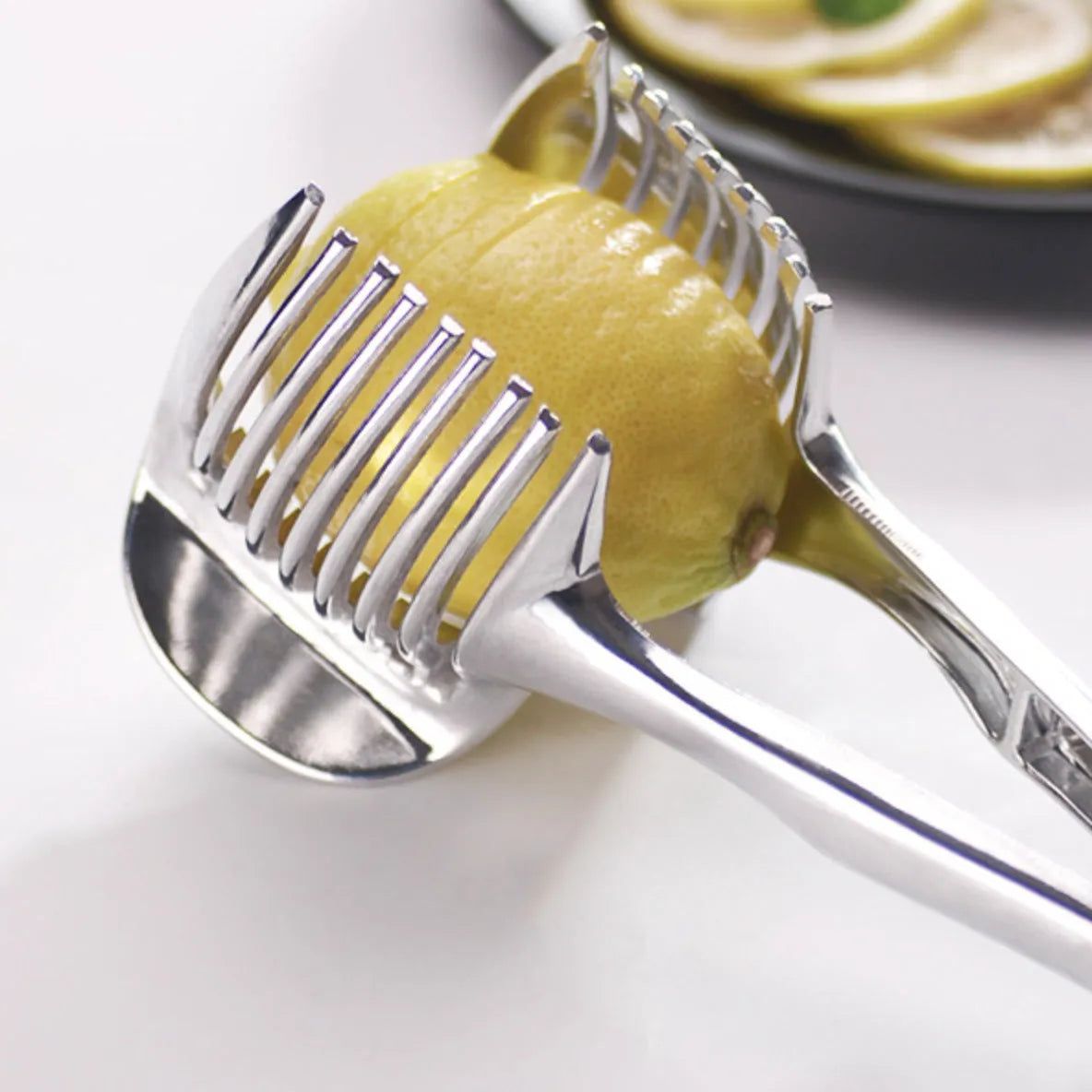 Silver plastic lemon slicer kitchen gadget for cutting fruit and vegetables