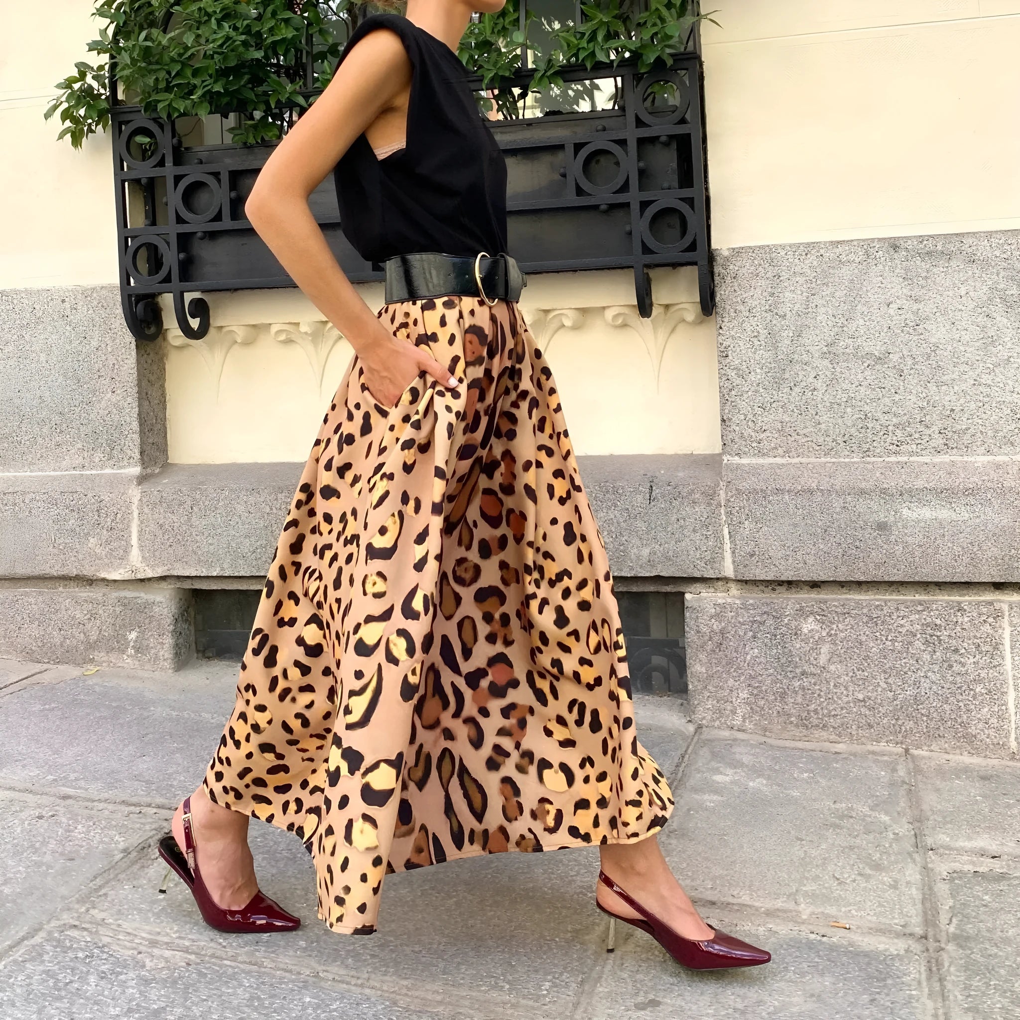 Women's long brown leopard print A-line skirt with a big hem.