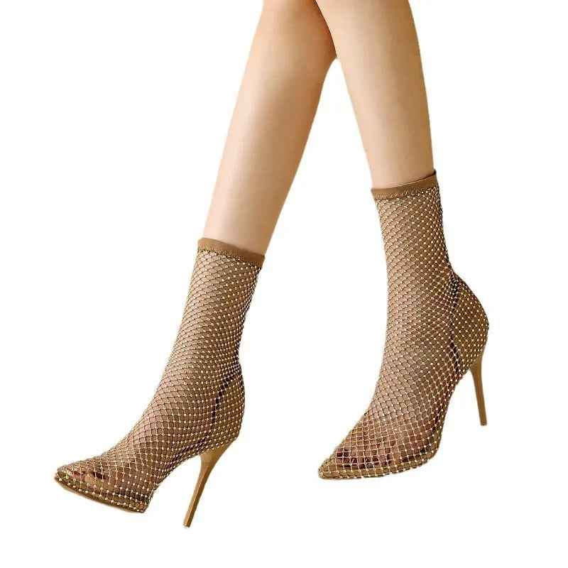 Gold women's high heel sandals with mesh upper, pointed toe, stiletto heel, and oversleeve design.