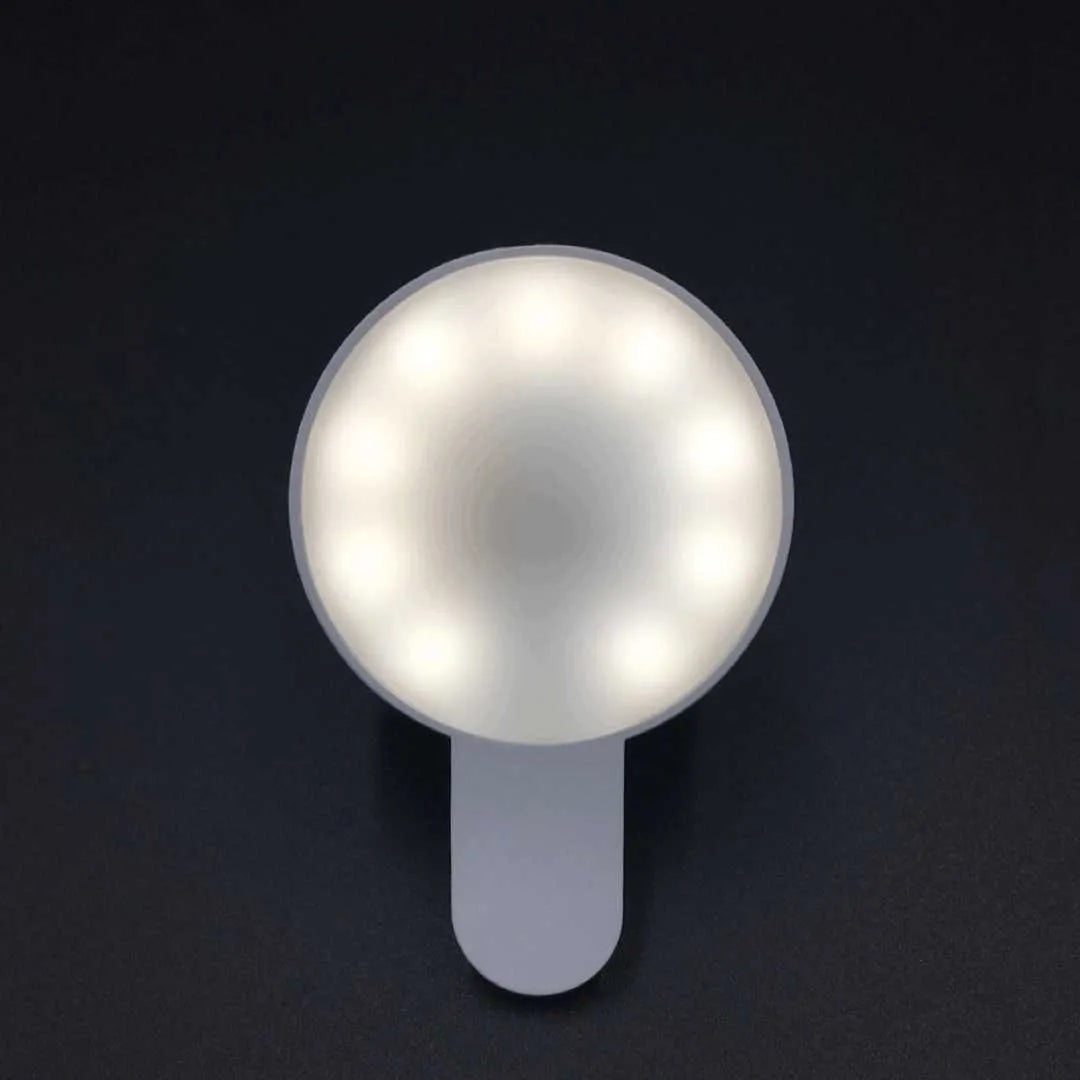 Compact white selfie fill light for mobile phones with three-level dimming switch and USB charging port.