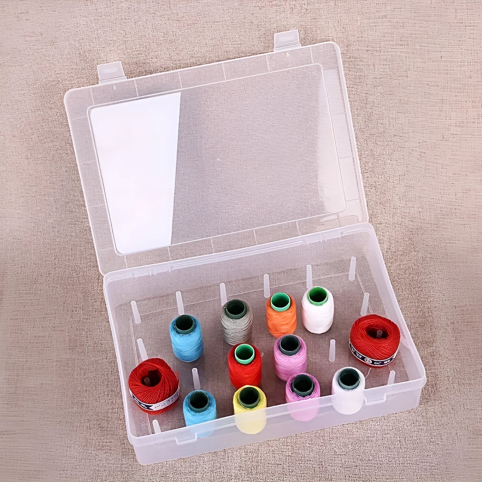 Transparent plastic box with 42 compartments for organising embroidery threads and sewing accessories.