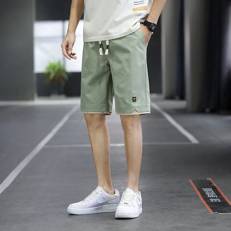 Men's loose-fit casual shorts in polyester fabric, shown in a solid colour with a straight Korean-style cut.