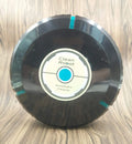 Black and white ABS plastic automatic robot vacuum cleaner on a wooden floor.