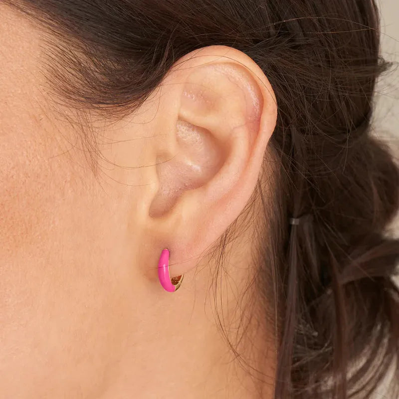 Geometric oval curved earrings for women in silver copper with a blue epoxy drip finish on a U-shaped wire.