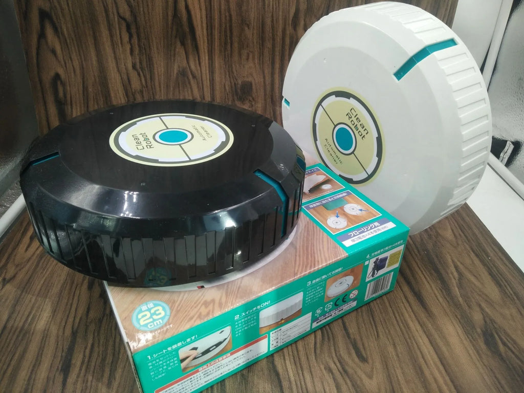 Black and white ABS plastic automatic robot vacuum cleaner on a wooden floor.
