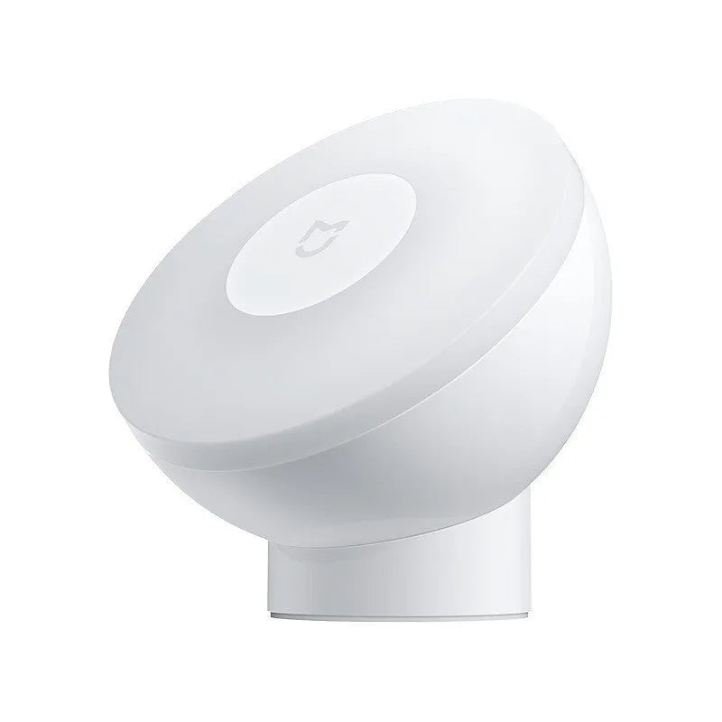 White Bluetooth induction bedside lamp with modern simple design on wooden nightstand