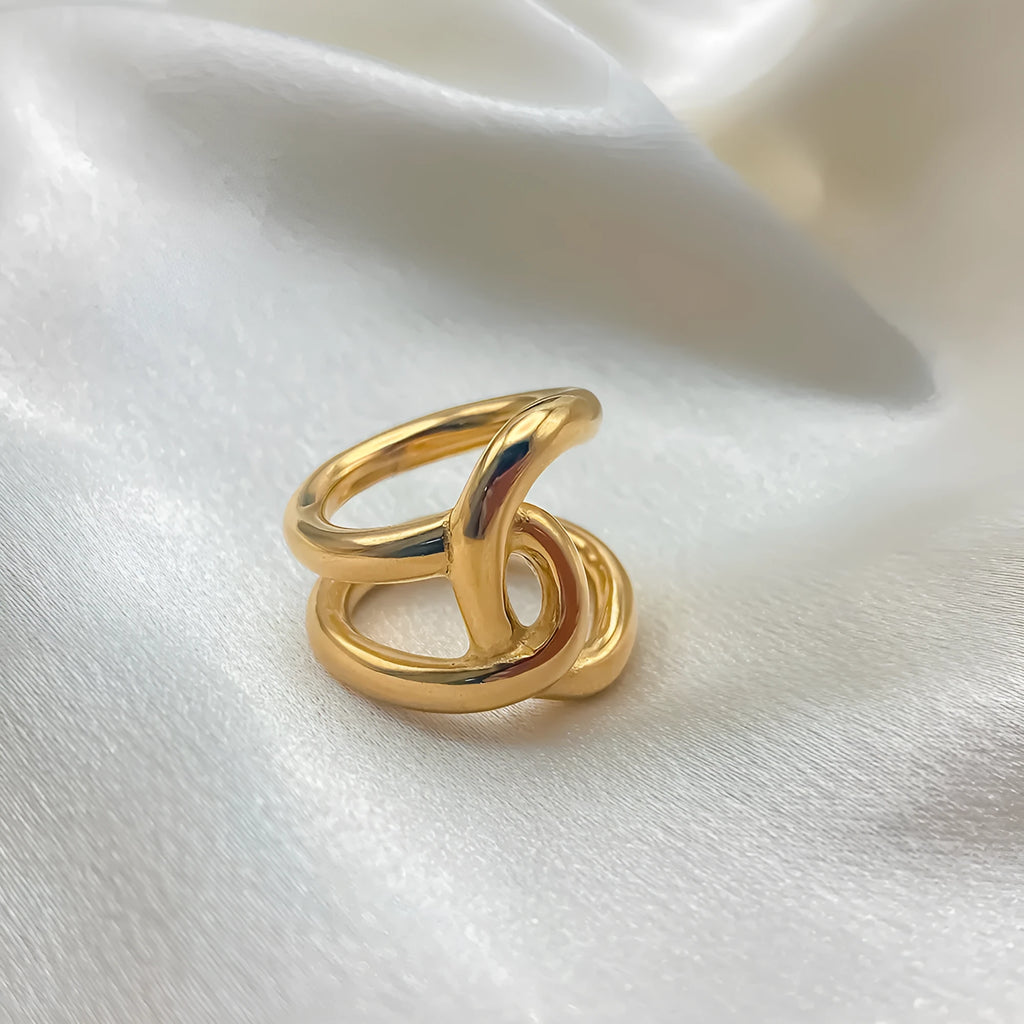 Geometric knotted women's adjustable ring in stainless steel, showing U-shaped opening.