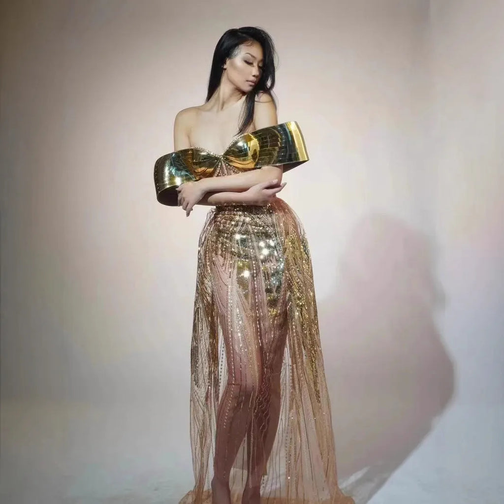 Gold strapless sequined formal dress with a side split on a long tulle skirt.