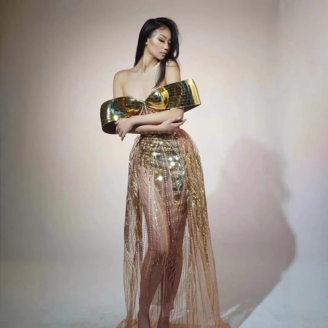 Gold strapless sequined formal dress with a side split on a long tulle skirt.