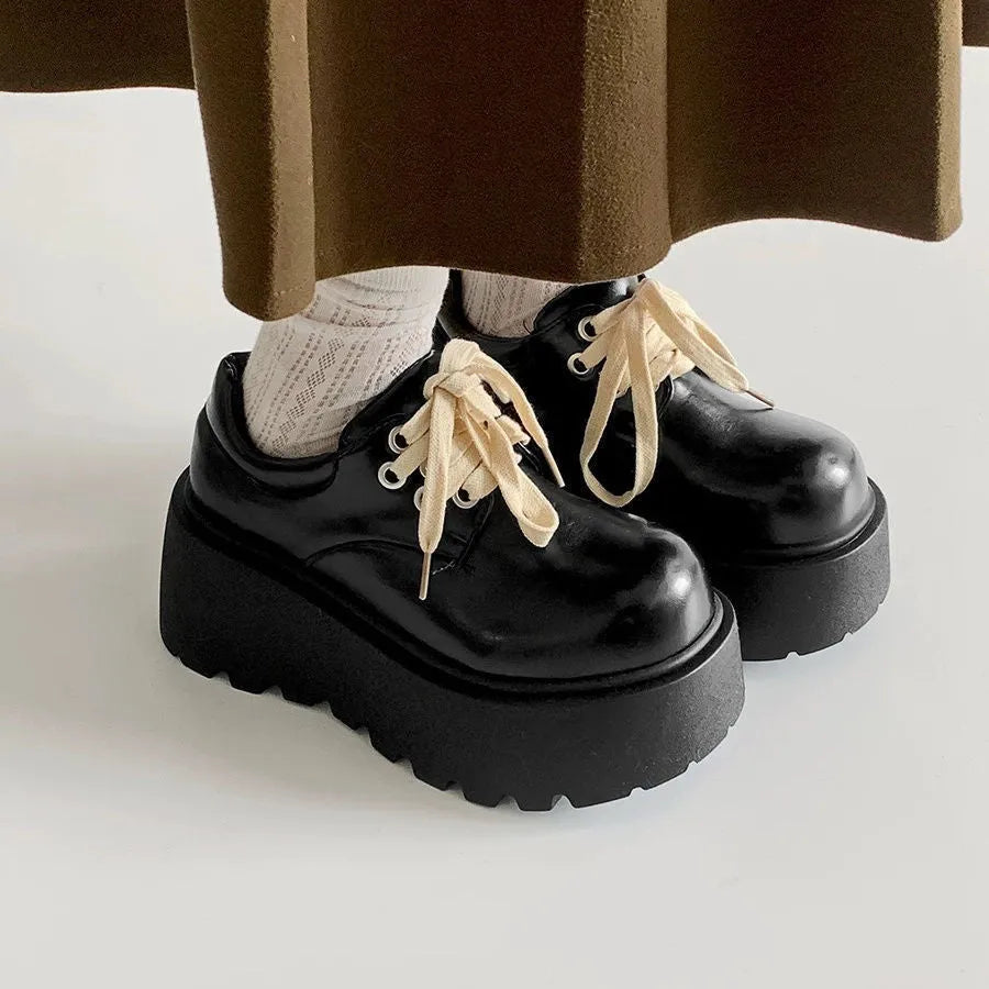 Matte black women's lace-up shoes with a high English muffin heel and thick rubber sole.
