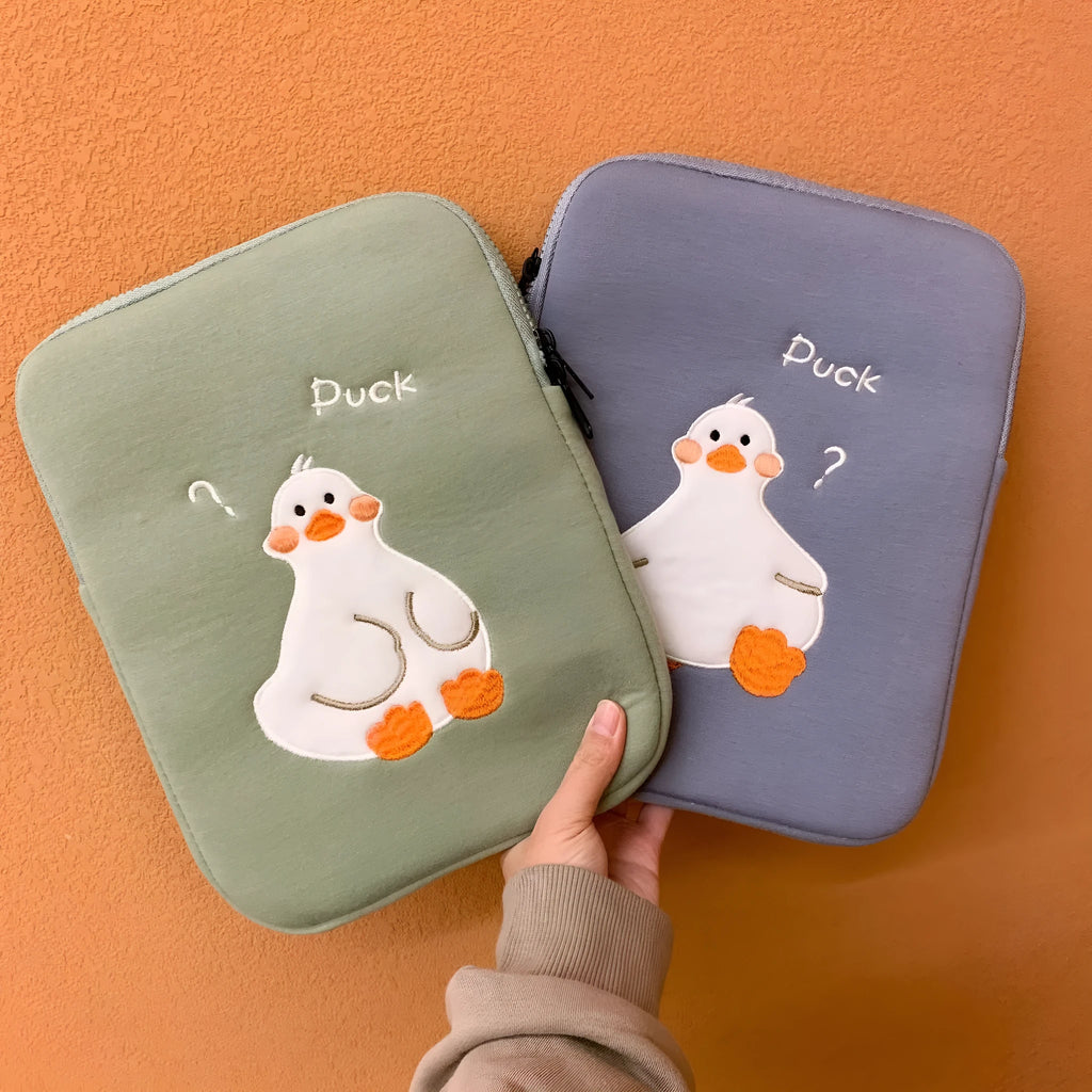 Blue cotton iPad case with embroidered cartoon duck design and a zipper.
