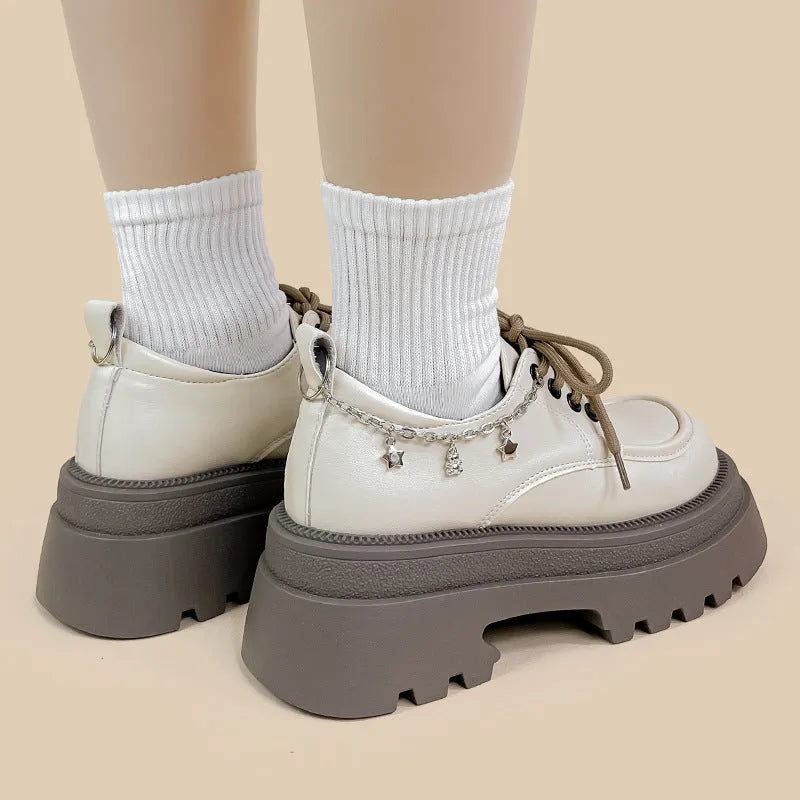 White women's platform leather shoes with lace-up front and a thick chunky heel.
