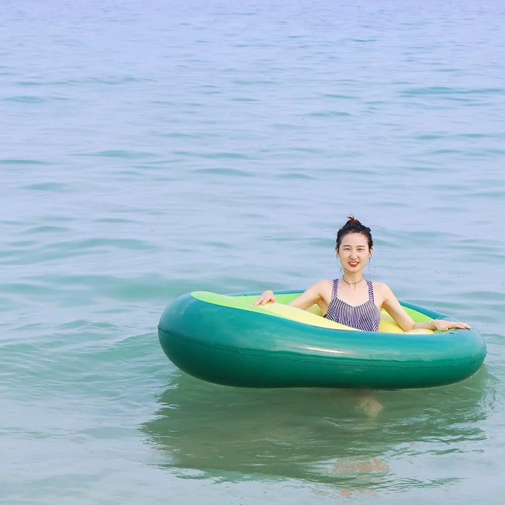Green giant avocado-shaped inflatable pool float on water