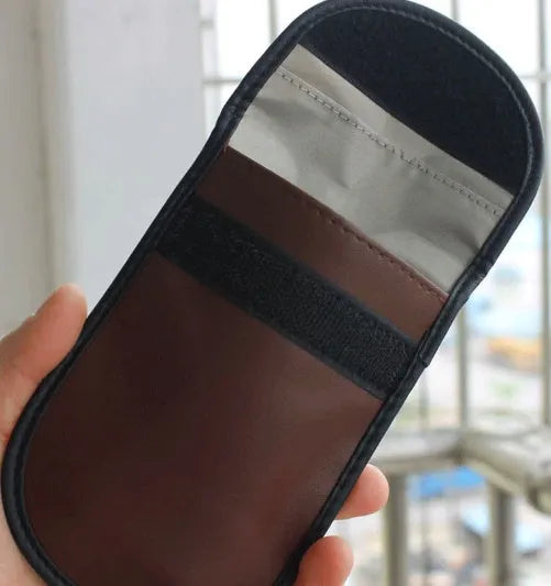 Black microfiber Faraday cage pouch for car key fob and RFID card protection.