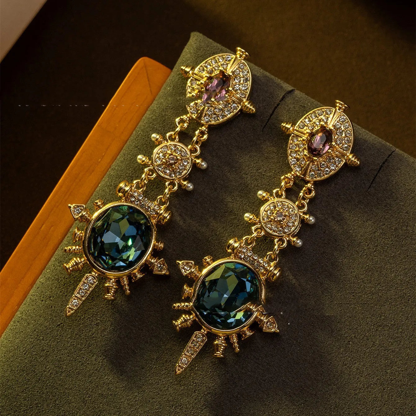 A pair of gold retro-style stud earrings with a geometry shape and round design elements.