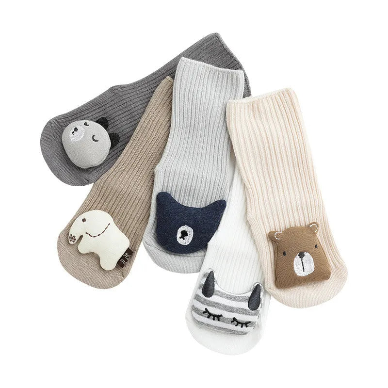 Baby socks with anti-slip glue dots on soles in combed cotton, showing mid-tube height and various colour options