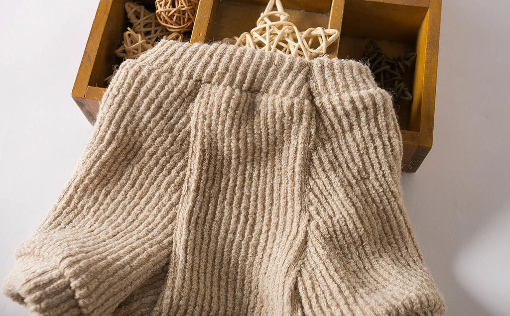 Brown knitted cloth pullover sweater on a small dog, showing casual style.