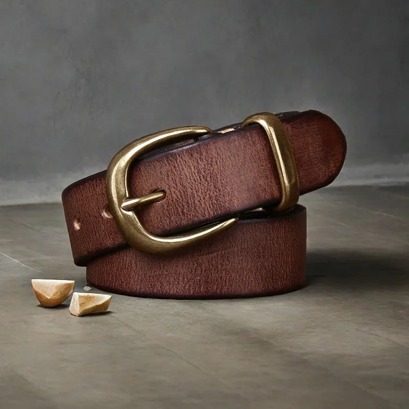 Men's brown casual leather belt with a copper pin buckle on a textured background.