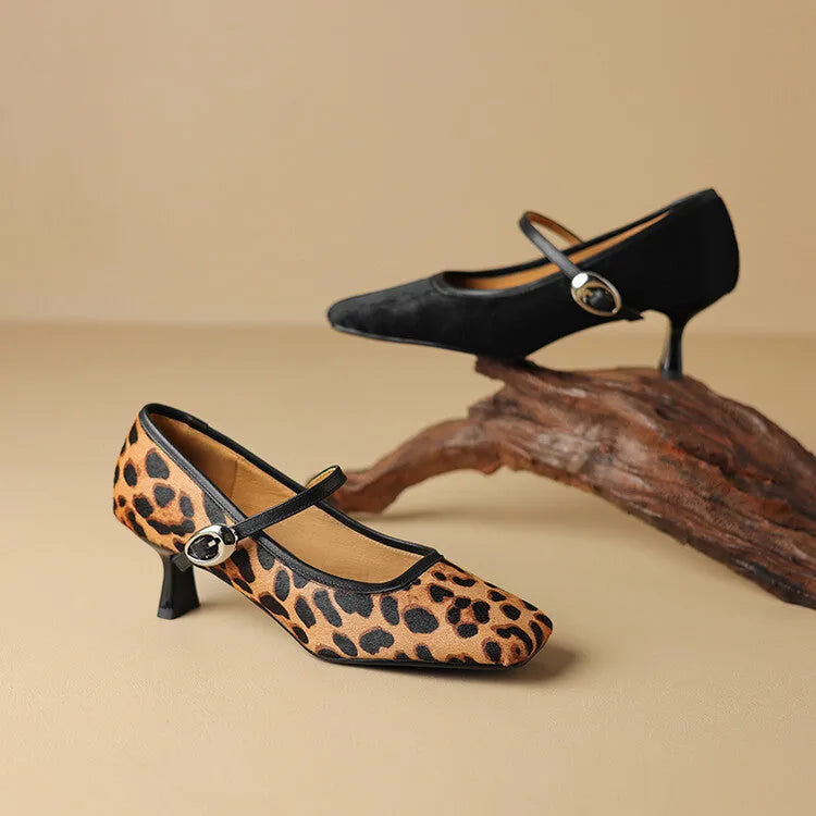 Women's black square toe stiletto heel ankle-strap shoes with horse hair upper on a model.