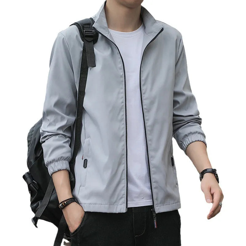 Men's Korean style loose lapel casual jacket in blue with zipper pockets.